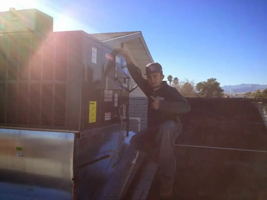 HVAC technician performing Air Duct Repair on a rooftop unit in Union
